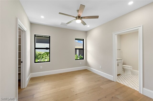 unfurnished bedroom with recessed lighting, light wood-style flooring, a ceiling fan, connected bathroom, and baseboards