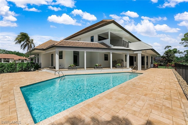 view of swimming pool featuring a fenced in pool, a patio area, and fence