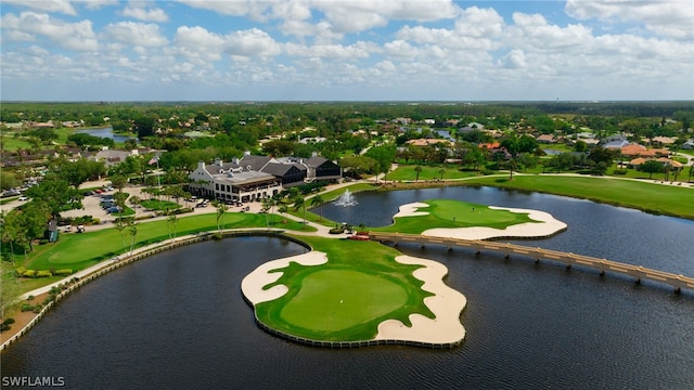 drone / aerial view with view of golf course and a water view