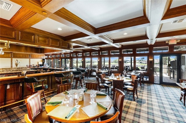 dining area with beamed ceiling, coffered ceiling, and light carpet