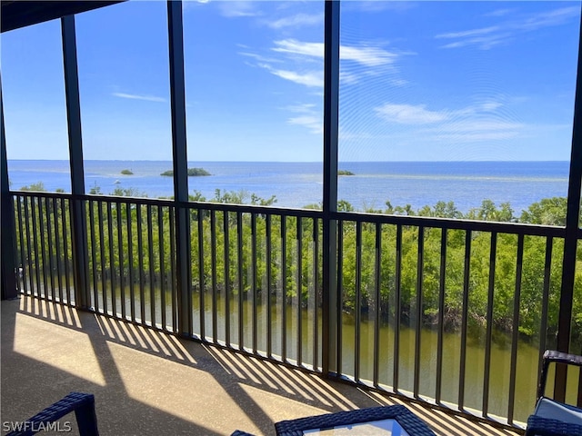 unfurnished sunroom featuring a water view and a healthy amount of sunlight