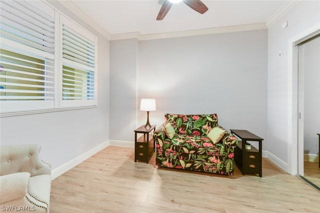 sitting room featuring light hardwood / wood-style floors, ceiling fan, and crown molding