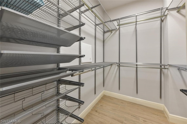 walk in closet featuring light hardwood / wood-style flooring