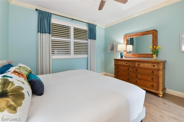 bedroom featuring ornamental molding, ceiling fan, and light wood-type flooring