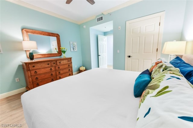 bedroom with ornamental molding, ceiling fan, and light wood-type flooring