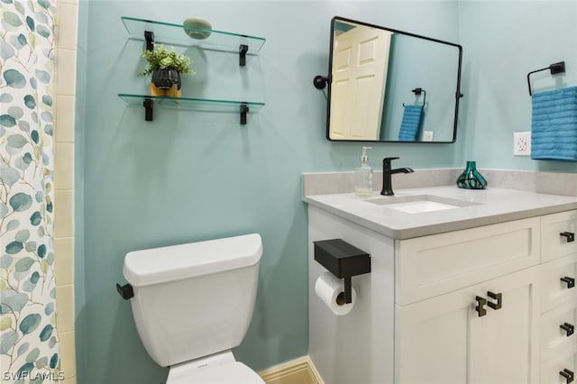 bathroom with toilet and vanity