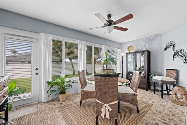 sunroom / solarium featuring ceiling fan