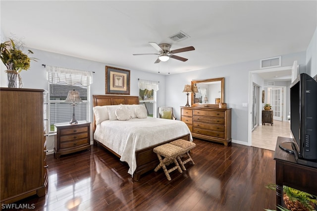 bedroom with multiple windows, ceiling fan, and dark hardwood / wood-style floors