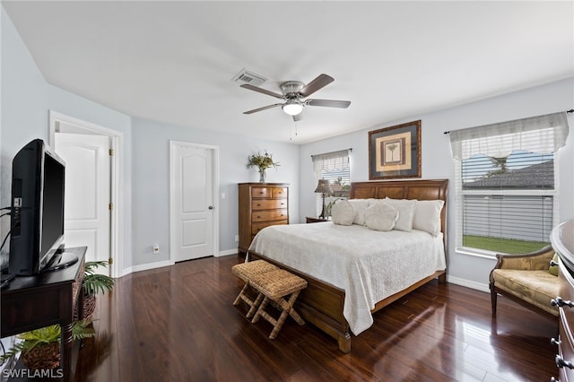 bedroom with dark hardwood / wood-style floors, multiple windows, and ceiling fan