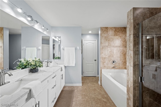 bathroom with shower with separate bathtub, vanity, and tile patterned floors