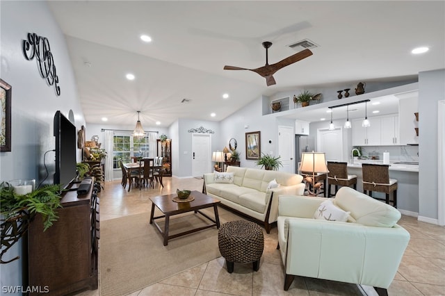 living room featuring ceiling fan, sink, light tile patterned floors, and vaulted ceiling