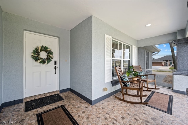 entrance to property featuring covered porch