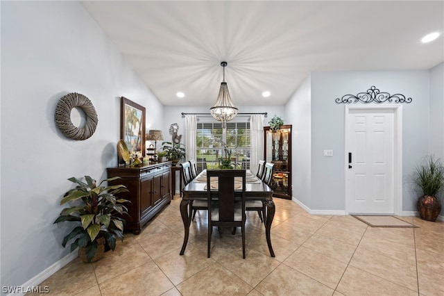 tiled dining room featuring a notable chandelier