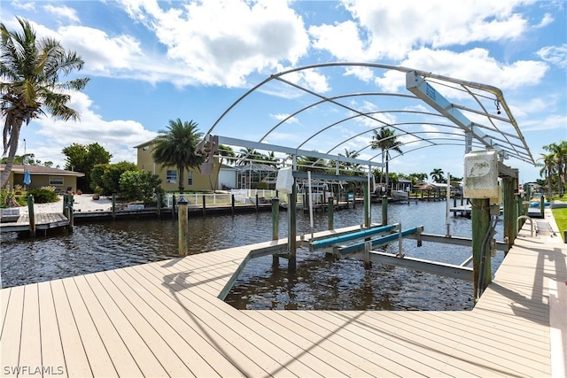 view of dock featuring boat lift and a water view