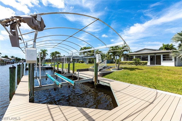 dock area featuring a lawn and a water view