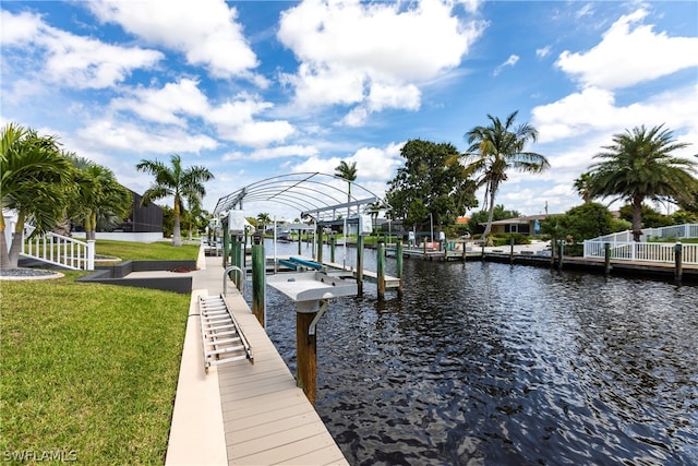 view of dock featuring a water view and a yard