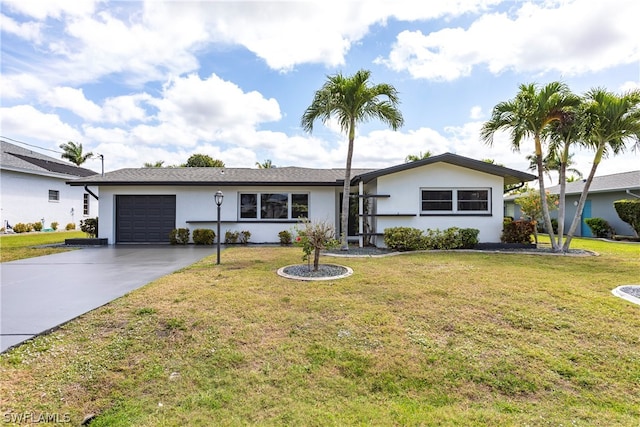 ranch-style house featuring a front lawn and a garage