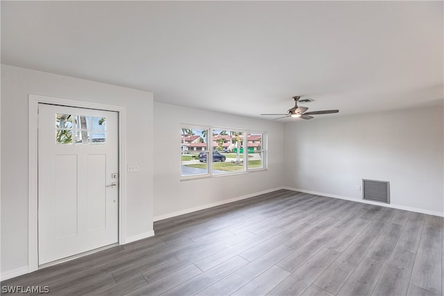 foyer entrance with plenty of natural light, dark wood-type flooring, and ceiling fan