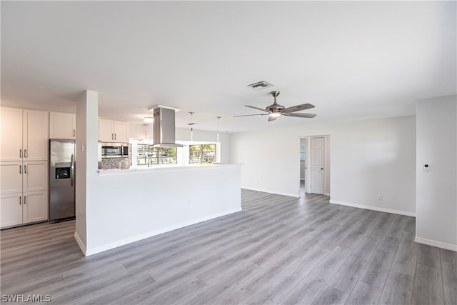 kitchen with light hardwood / wood-style floors, stainless steel appliances, ceiling fan, and white cabinets