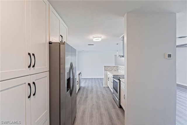 kitchen featuring stainless steel appliances, white cabinets, and light wood-type flooring