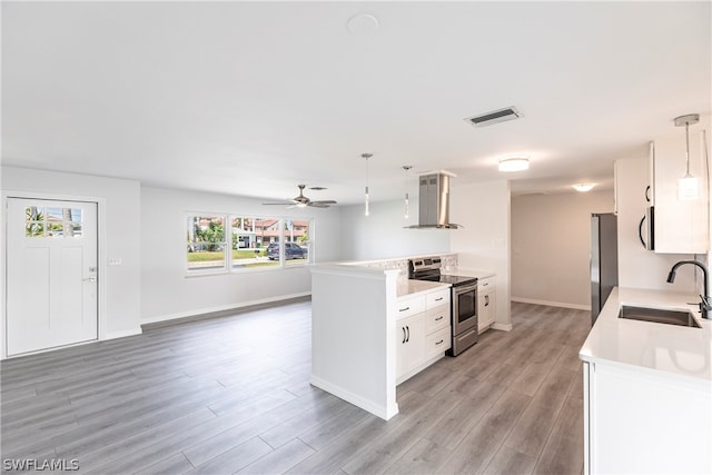 kitchen with ceiling fan, appliances with stainless steel finishes, sink, white cabinets, and pendant lighting