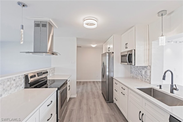 kitchen featuring decorative light fixtures, backsplash, range hood, sink, and stainless steel appliances