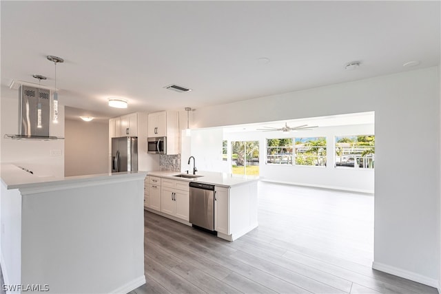 kitchen with ceiling fan, sink, appliances with stainless steel finishes, light hardwood / wood-style flooring, and white cabinetry