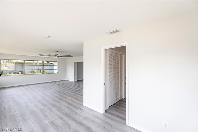 empty room featuring ceiling fan and light wood-type flooring