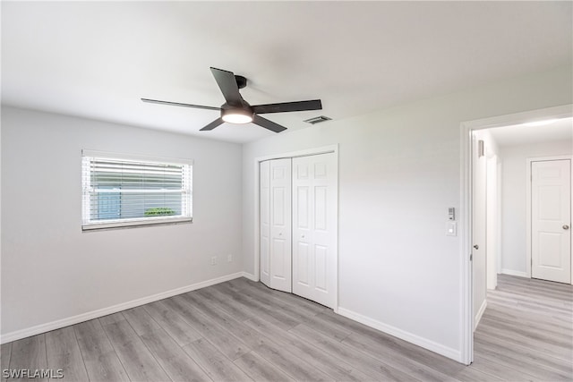 unfurnished bedroom with a closet, ceiling fan, and light wood-type flooring