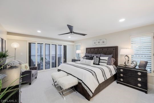 bedroom featuring light carpet, multiple windows, and ceiling fan