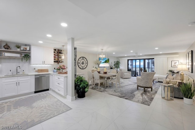 tiled living room featuring sink and a chandelier