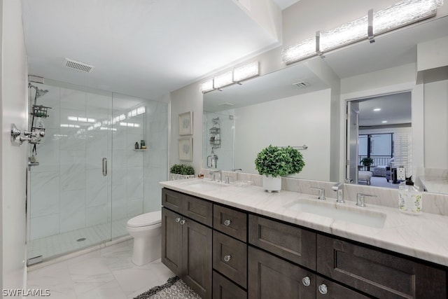 bathroom featuring toilet, double sink, a shower with shower door, tile floors, and oversized vanity