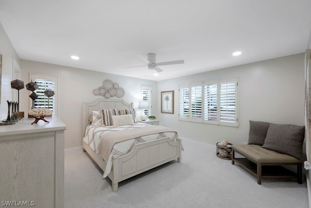 carpeted bedroom with ceiling fan and multiple windows