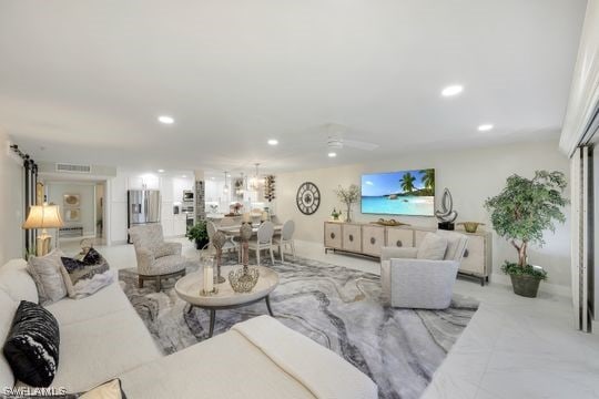 living room with light tile floors and ceiling fan