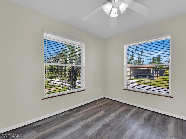 spare room featuring ceiling fan and dark wood-type flooring