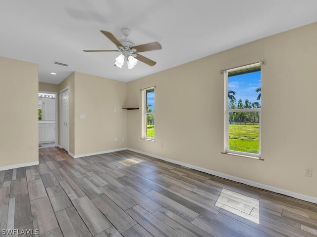 empty room with light hardwood / wood-style flooring and ceiling fan