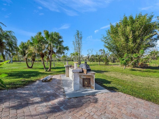 view of property's community with a patio and a yard