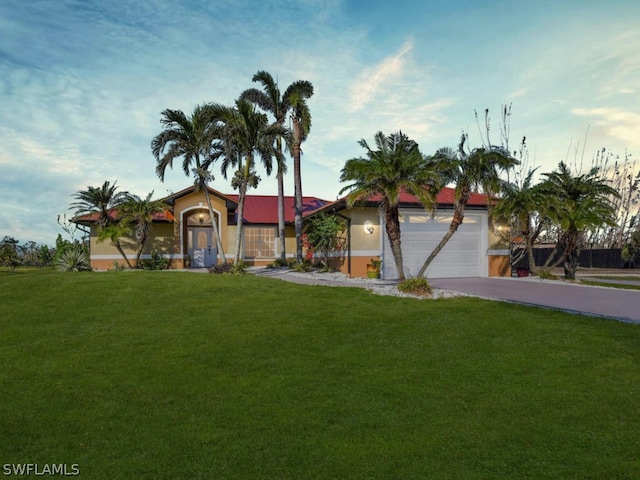 ranch-style house featuring a garage and a front yard