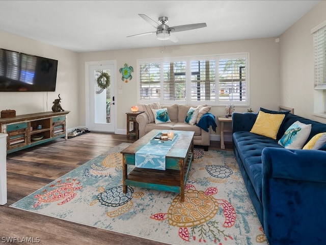 living room featuring dark hardwood / wood-style flooring and ceiling fan