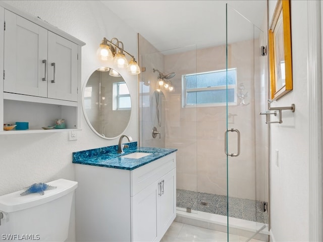 bathroom with walk in shower, toilet, tile flooring, and vanity