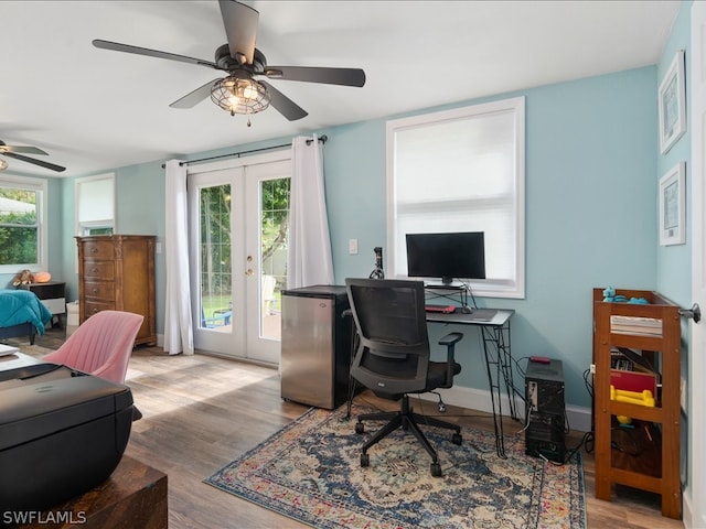 office space with french doors, ceiling fan, and light hardwood / wood-style floors