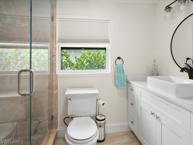 bathroom with plenty of natural light, vanity, an enclosed shower, and toilet