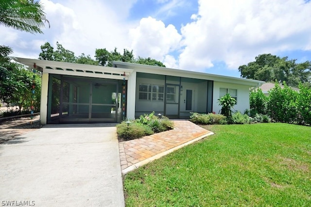 ranch-style home with a sunroom and a front yard