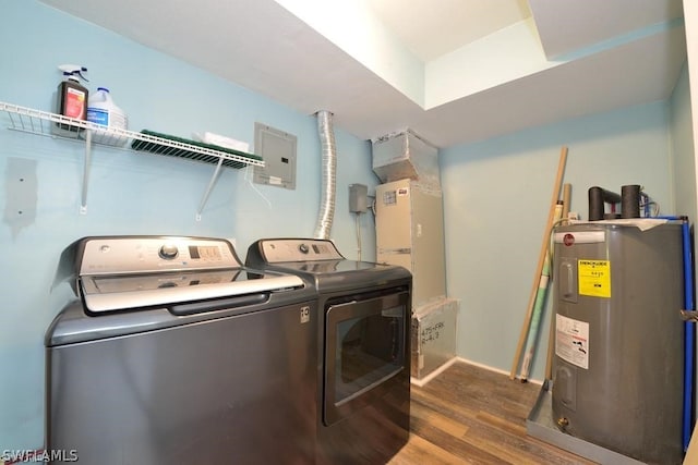 washroom with dark wood-type flooring, separate washer and dryer, and electric water heater