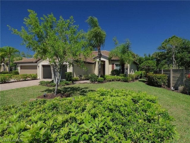 mediterranean / spanish home with a front lawn and a garage