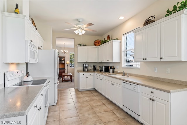 kitchen with white cabinetry, ceiling fan with notable chandelier, white appliances, and light tile floors