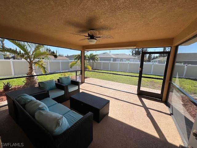 sunroom with ceiling fan