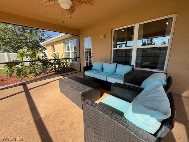 view of patio with ceiling fan and an outdoor hangout area