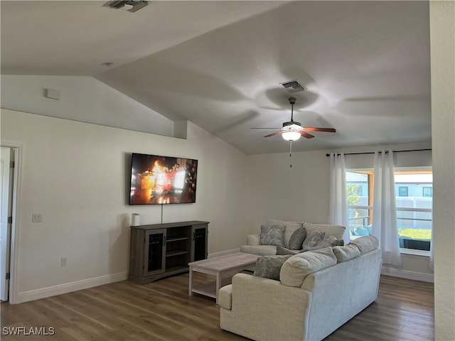 living room with ceiling fan, dark wood-type flooring, and vaulted ceiling