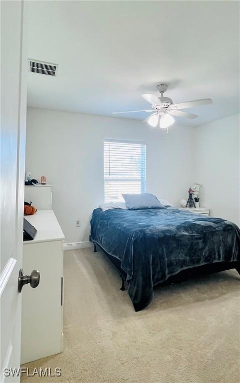 bedroom with ceiling fan and carpet floors